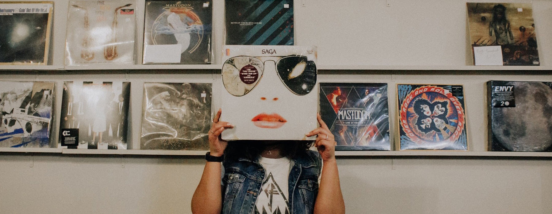 Person posing with a record 